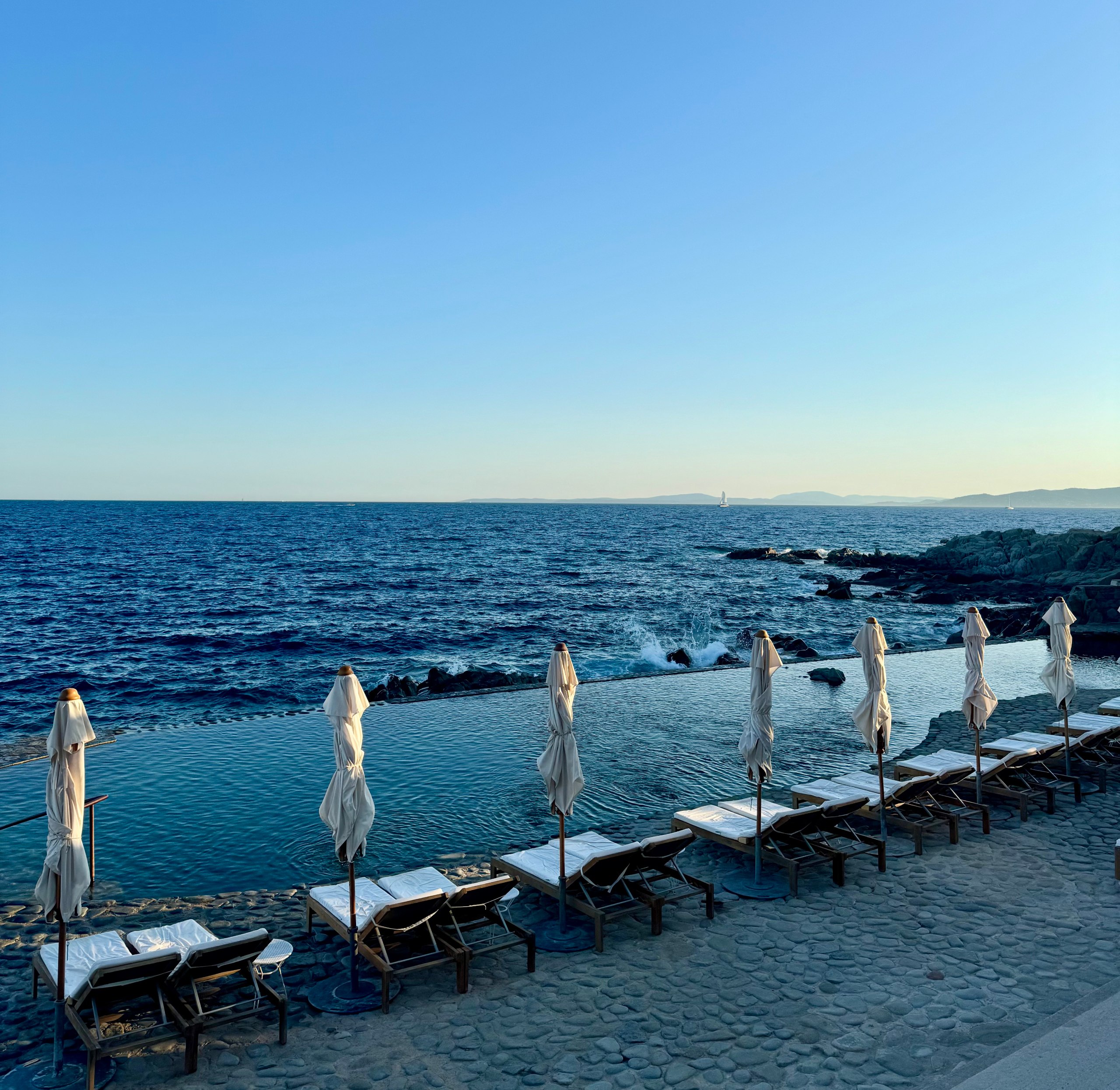 Mediterranean luxury hotel infinity pool — recommended by Summer & Beyond Travel