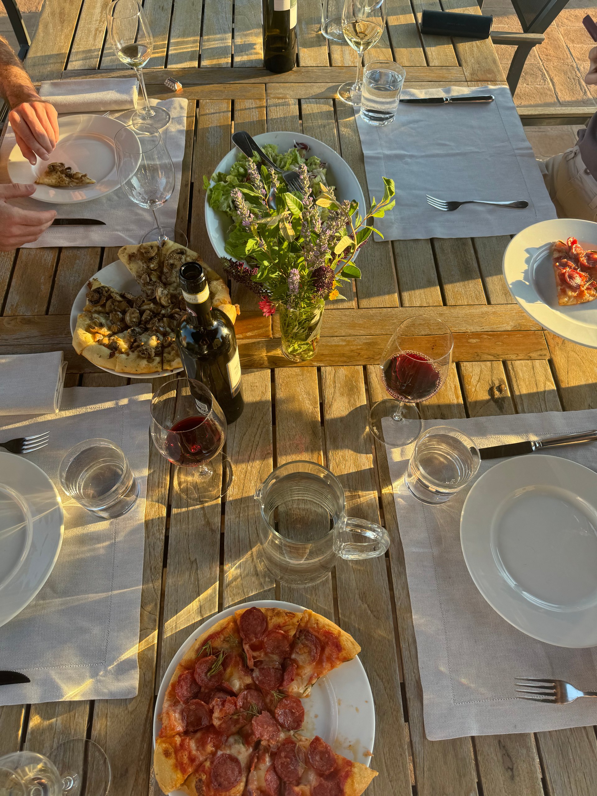 Al fresco Italian dinner with pizza and wine